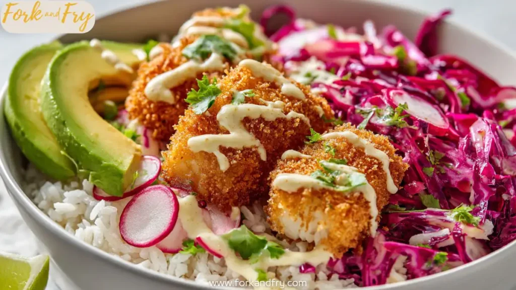 Crispy fish taco bowl with slaw, rice, and creamy chipotle sauce