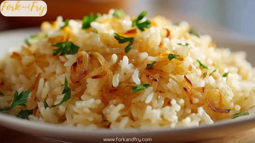 A bowl of golden rice with caramelized onions and fresh herbs