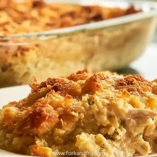 creamy chicken casserole slice with golden crust served on a white plate