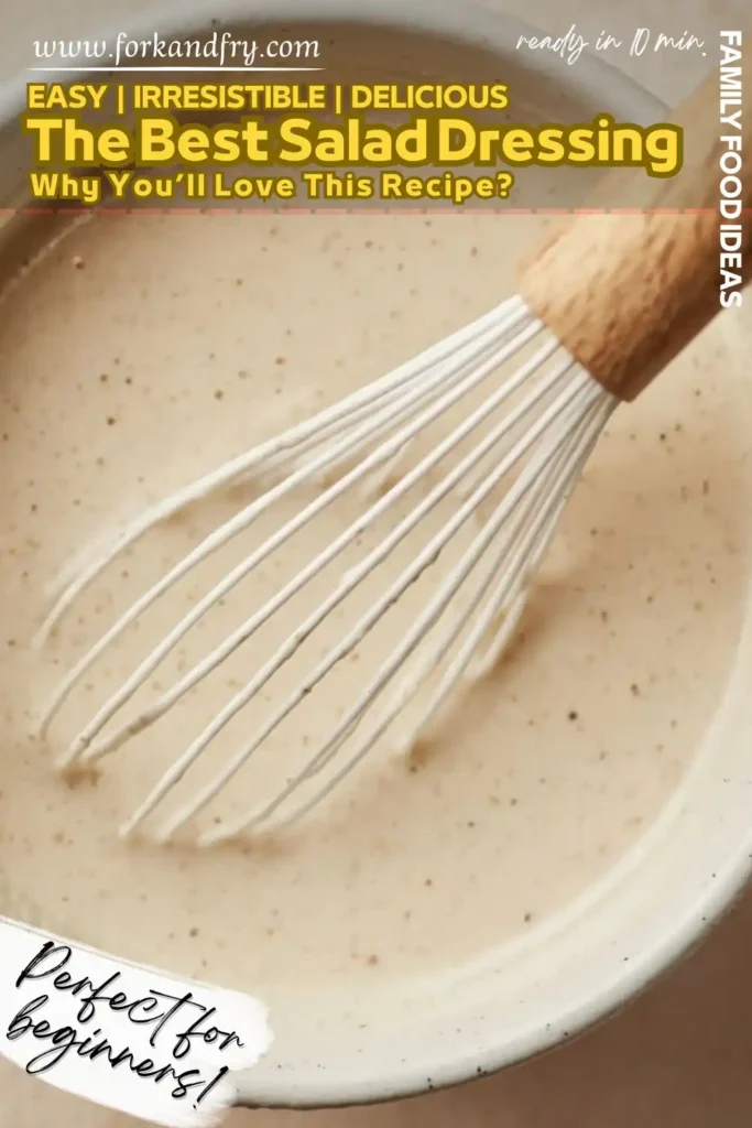 creamy salad dressing being whisked in speckled ceramic bowl