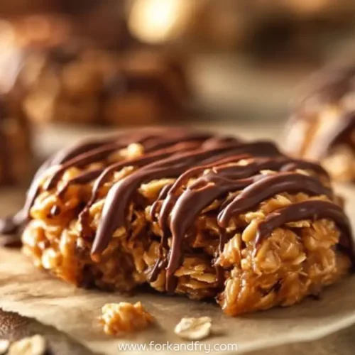 Chewy oat cookie topped with chocolate drizzle and caramelized peanut butter, perfect for dessert lovers