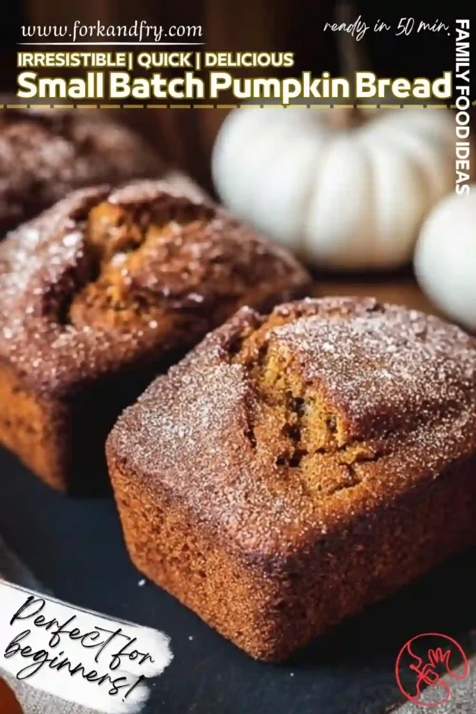 Mini Pumpkin Bread Loaves for Small Batch Baking Mini pumpkin bread loaves sprinkled with sugar on black slate styled vertically with white pumpkins in background